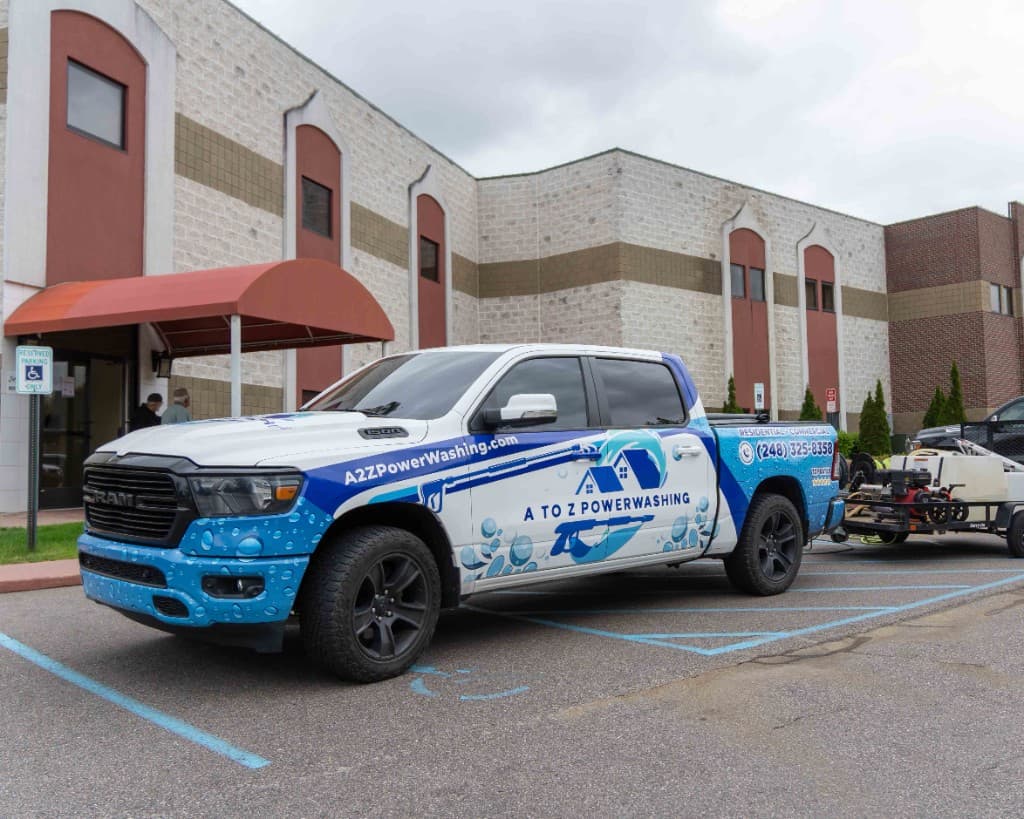 A to Z Power Washing commercial cleaning truck parked outside a large building