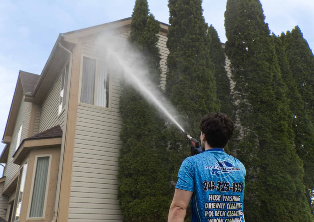 A to Z Power Washing technician soft washing a home exterior
