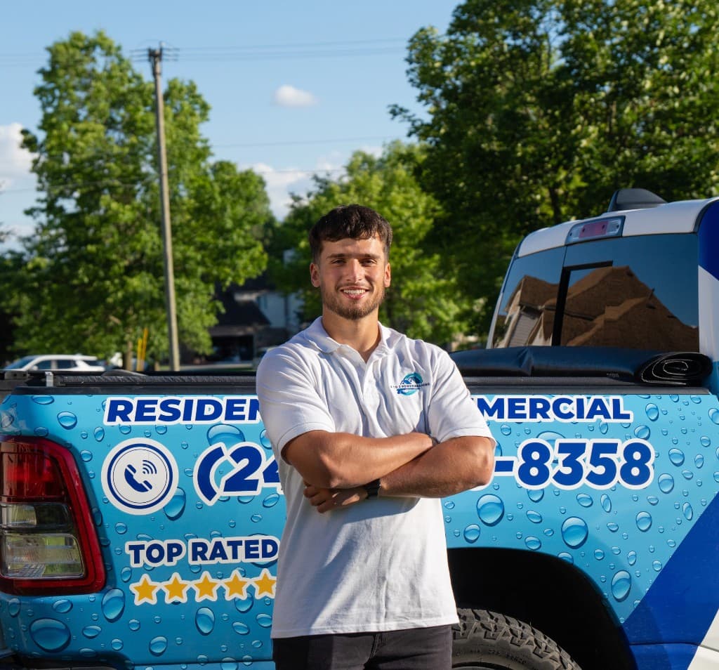 KB, owner of A to Z Power Washing, standing in front of the company service truck
